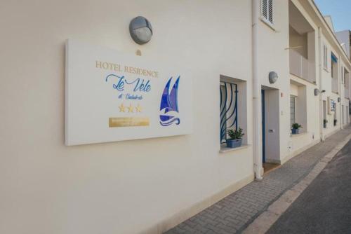 a sign on the side of a white building at Le Vele di Balestrate in Balestrate