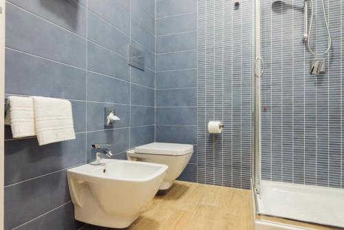 a bathroom with a toilet and a sink and a shower at Le Vele di Balestrate in Balestrate