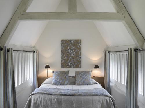 A bed or beds in a room at Les Manoirs de Tourgéville