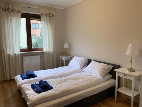 a bedroom with two beds with towels on them at Charlotte by Q4Apartments in Gdańsk