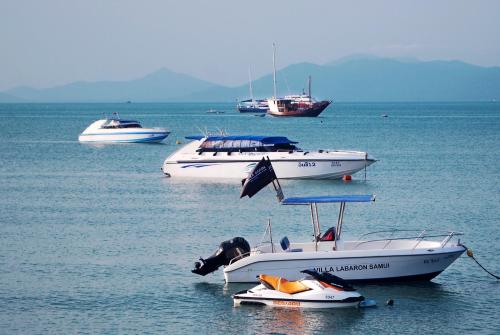 a group of boats sitting in the water at Villa Labaron in Koh Samui 