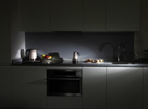 a kitchen with a sink and a counter top at HOTEL AD Residence in Bormio