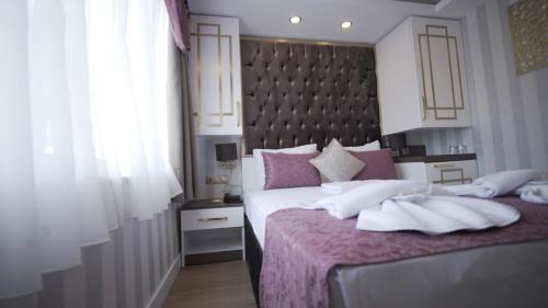 a bedroom with two beds and a large headboard at Burj Al Istanbul in Istanbul