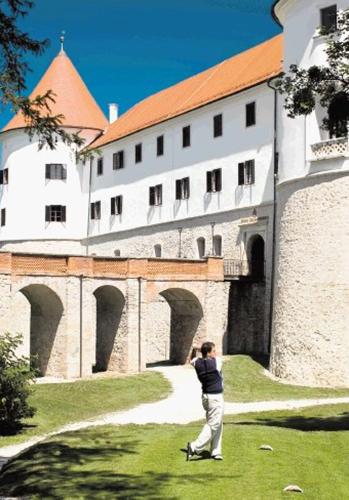 a man taking a picture of a building at Aparthouse SUPREME with Terme Catez Swimming Pools Tickets in Čatež ob Savi