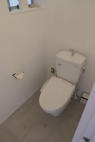 a bathroom with a white toilet in a room at WhyKumano in Nachikatsuura
