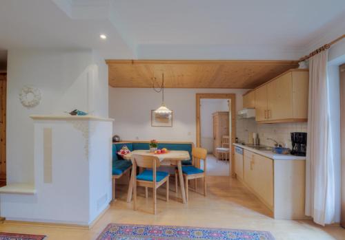 a kitchen and dining room with a table and chairs at Landhaus Johannes in Mayrhofen
