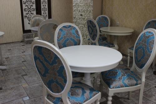 a group of chairs and a white table and chairs at Borjomi Classic Hotel in Borjomi