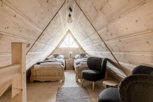 a room with four beds in a wooden house at TatryTop Osada Luxury Chalets Kościelisko in Kościelisko