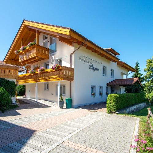 a large white building with a balcony on it at Boutique Hotel Angerer in Murnau am Staffelsee