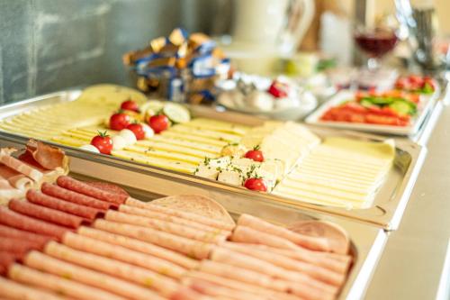 a buffet with many different types of meats and cheese at Boutique Hotel Angerer in Murnau am Staffelsee