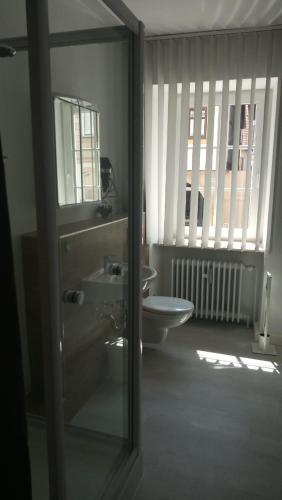 a bathroom with a sink and a toilet at City Apartments Ebern in Ebern