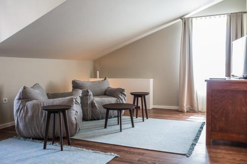 a living room with a couch and two tables at Boutique Hotel Boškinac in Novalja