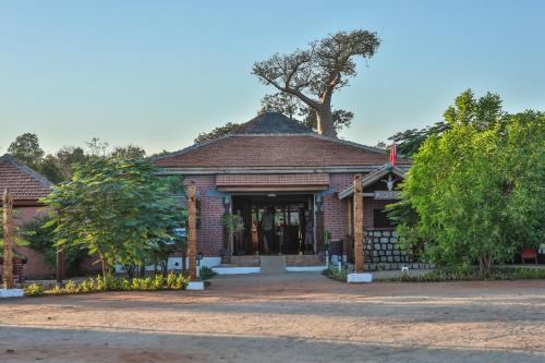 a brick house with a tree on top of it at RELAIS DU KIRINDY in Kirindy