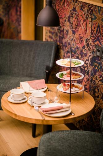 a wooden table with plates of food on it at Weinhotel Freylich Zahn in Freyburg