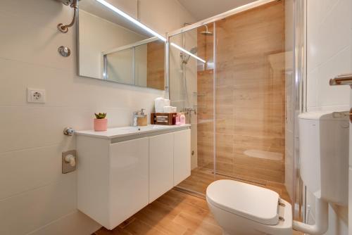 a bathroom with a white toilet and a shower at Apartment Saint Michael in Šibenik
