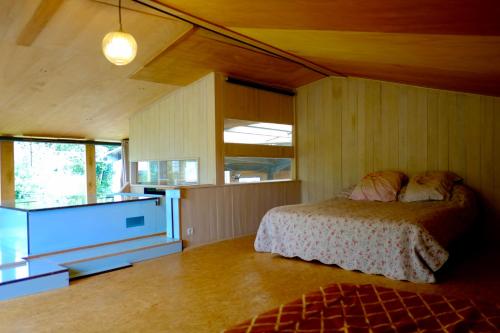 a bedroom with a bed and a window in it at Chambres d'hôtes des Forges in Cellefrouin