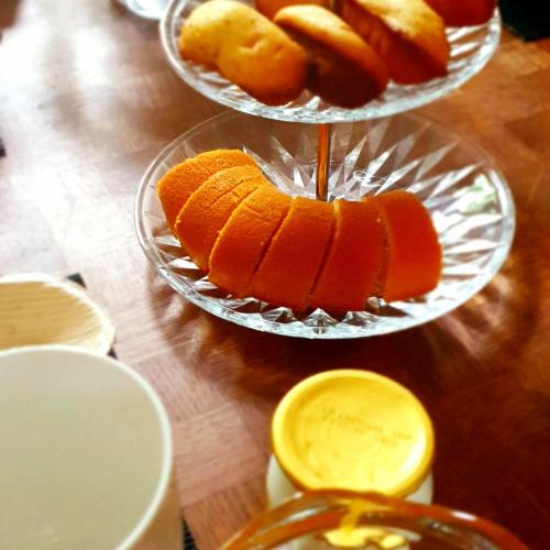 a wooden table with three tiers of fruit on plates at Maison de maître à BRAM # Jacuzzi in Bram