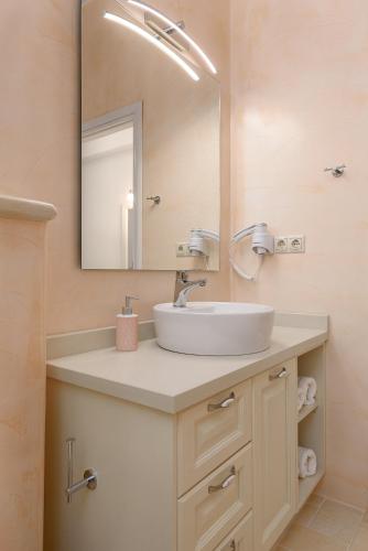 a bathroom with a sink and a mirror at Villa Salla Luxury in Sívas