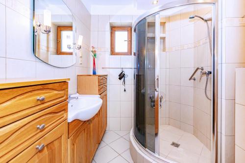 a bathroom with a shower and a sink at Apartamenty Maciejka in Władysławowo