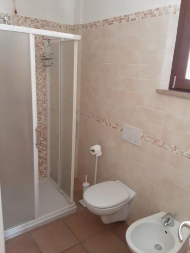 a bathroom with a shower and a toilet and a sink at Fonte la Perna in Polverigi