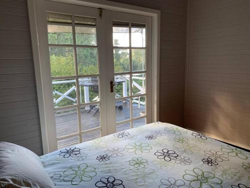 a bedroom with a bed and a window with a bedspread at Warby Weekender in Warburton