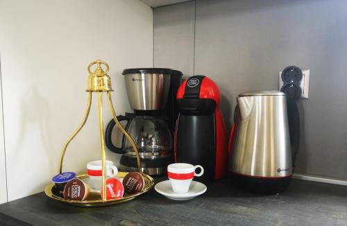 a kitchen counter with a coffee maker and coffee cups at Gems of Pinakates in Pinakátai
