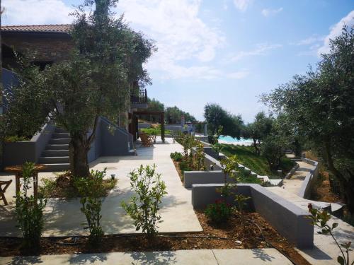 a garden with stairs and trees and a sidewalk at Gems of Pinakates in Pinakátai