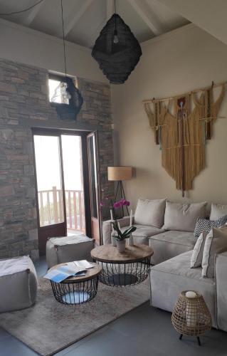 a living room with a couch and a table at Gems of Pinakates in Pinakátai