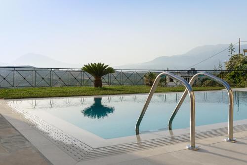 a swimming pool with two metal rails around it at Villa Salla Luxury in Sívas