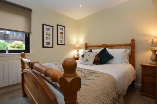 a bedroom with a large bed and a window at Dolphin Run in Hunters Quay