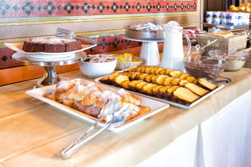 a buffet with several trays of food on a table at Villa Pitiana in Donnini