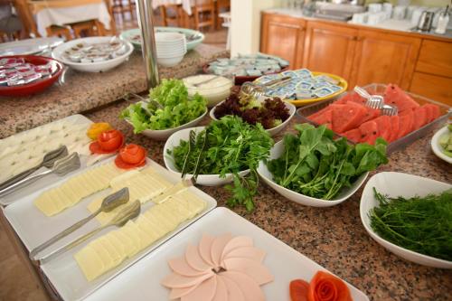 a counter topped with lots of different types of food at Belcehan Hotel in Oludeniz