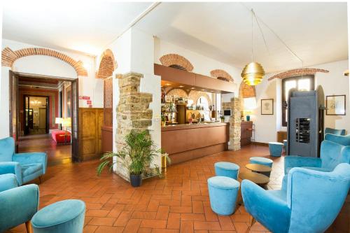 a waiting room with blue chairs and a counter at Villa Pitiana in Donnini