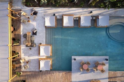 an overhead view of a pool with tables and chairs at The Syntopia Hotel - Adults Only in Adelianos Kampos