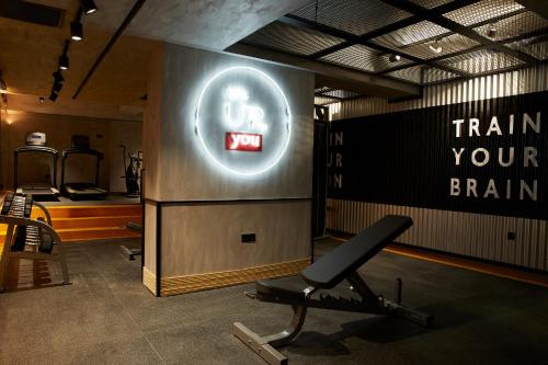 a gym with a chair and a sign that says train your brain at The Syntopia Hotel - Adults Only in Adelianos Kampos