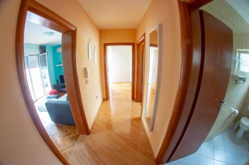 a view of a hallway in a house with a mirror at Apartments Neda in Kampor