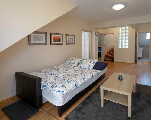 A bed or beds in a room at Airport Apartman