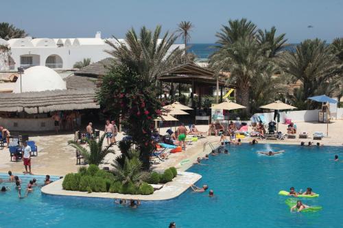 a swimming pool filled with lots of people at Seabel Rym Beach Djerba in Taguermess