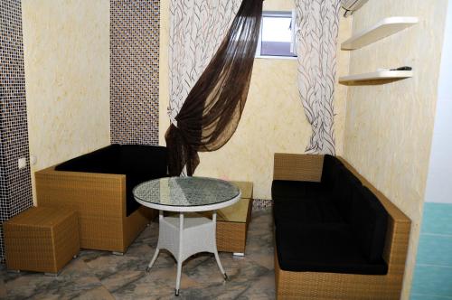 a small room with a table and a window at Totem Hotel in Shymkent