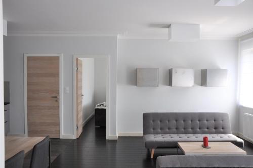 a living room with a couch and a table at Ludwinowska11 Apartments in Kraków