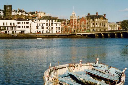 two boats are docked in the water in a city at Ellerton B&B in Bideford