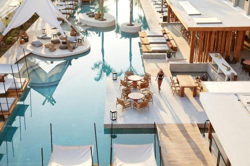 an overhead view of a pool with tables and chairs at The Syntopia Hotel - Adults Only in Adelianos Kampos