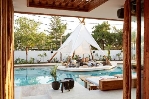 a swimming pool with a boat in the middle of a house at The Syntopia Hotel - Adults Only in Adelianos Kampos