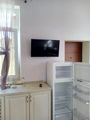 a living room with a tv on the wall at Дом на берегу Черного Моря in Zatoka