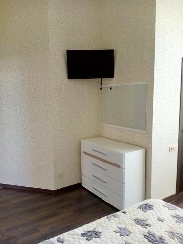 a bedroom with a white dresser and a mirror at Дом на берегу Черного Моря in Zatoka