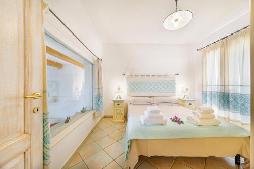 Кровать или кровати в номере Villa con vista Porto San Paolo