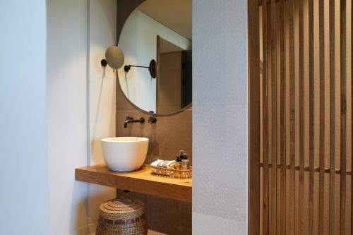 a bathroom with a sink and a mirror at The Syntopia Hotel - Adults Only in Adelianos Kampos
