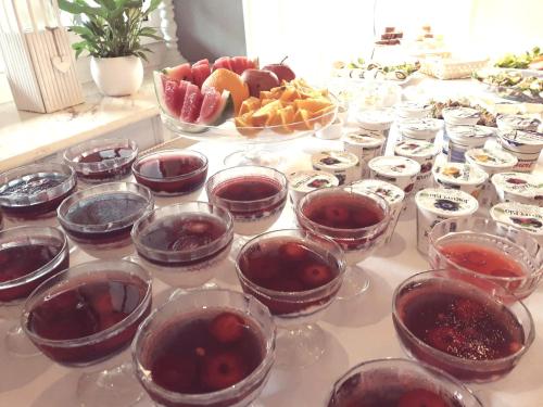 a table topped with bowls of jam and fruit at apartamenty kamienica in Puck