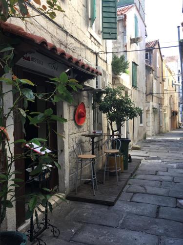 an alley with a table and chairs on a street at Studio Milla in Split