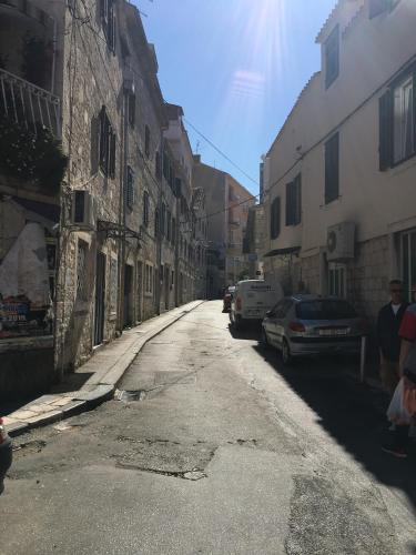 an empty street with cars parked on the side of a building at Studio Milla in Split